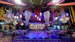 multicolored wedding decor and setup, floral area decor, hanging chandeliers, mehndi decorations