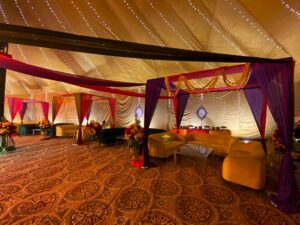 mayoun-wedding-decor colourful mehndi setup, sofa seating, fairy lights decor, multicolored draping