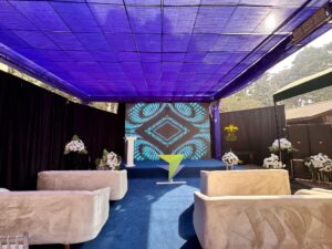 carpeted stage, sofa sitting, sound system, multimedia