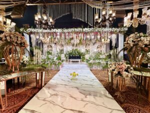 grand-stages-designers marble walkway, indoor setup, hanging chandeliers, wedding designers