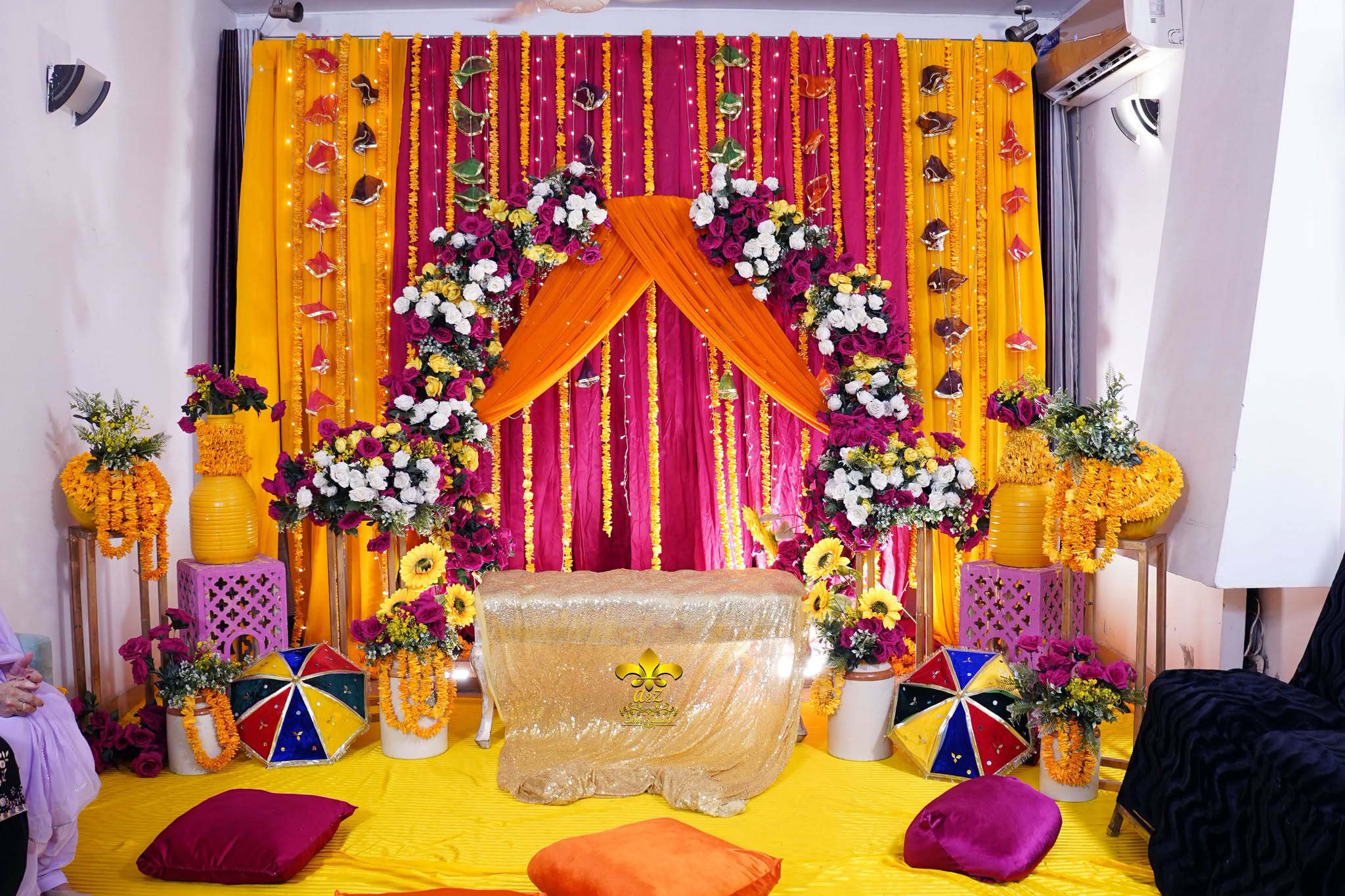 home based ceremony, wedding management, dholak setup, floral backdrop